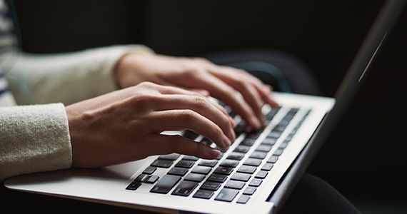 Person typing on laptop